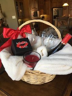 a basket filled with wine, candles and other items