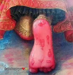 the foot of a pink statue under a red cloth