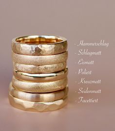 five different types of wedding rings with names on them, all in gold and silver