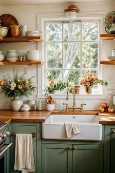 a kitchen with green cabinets and wooden counter tops, white walls and open shelving above the sink