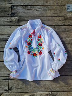 Traditional Hungarian Matyó white floral hand embroidered and hand smocked blouse . This blouse is new, material is 100% cotton. Peasant blouse, colorful peasant blouse, embroidered blouse, embroidered peasant blouse, floral blouse, ethnic embroidered blouse Beautiful wide shape boho, hippie, folk blouse with floral embroidered pattern.  Handmade blouse M Size Length:  22,5" inch bust: 45 inch Hand wash only. If you are buying several pieces I can combine postage at the time of mailing. If you h Traditional Spring Blouse With Machine Embroidery, Traditional White Blouse With Machine Embroidery, White Traditional Blouse With Machine Embroidery, Handmade White Blouse For Spring, Embroidery Unique, Handmade Blouse, Smock Blouse, Womens Blouses, Hand Smock