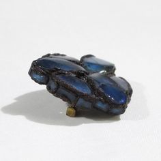 This is part of Chairish’s Costume Jewelry assortment.  This elegant Talosel or resin brooch pin was created by Line Vautrin in the 1950s. Features a freeform dimensional shape in black Talosel, encrusted with cobalt blue colored mirrored glass.  Glass and Talosel, a technique created by Line Vautrin, in which she used cellulose acetate that was fractured into tiny splinters and worked with heat. The creation process of Talosel jewelry involved many steps, including making the mirrors, coloring Line Vautrin, Resin Brooch, Tinted Mirror, Dimensional Shapes, Colored Mirror, Blue Mirror, Cellulose Acetate, Small Mirrors, Blue Mirrors