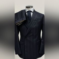 Navy Pinstripe 100% Super 150 Cerruti 1881 One Button Double Breasted Wool Suit Made In Italy. From Los Angeles Based Italian Men’s Suit And Leather Goods Collection Ticket Pocket 5 Inch Peak Lapel One Button Double Breasted Double Vent On Suit Flat Front Pant Open Button Sleeves Classic Striped Double Breasted Suit For Office, Elegant Striped Double Breasted Suit For Business, Classic Striped Double Breasted Suit For Formal Occasions, Elegant Formal Blazer With Vertical Stripes, Elegant Pinstripe Blazer With Buttons, Elegant Formal Suits With Vertical Stripes, Elegant Suits With Vertical Stripes For Formal Occasions, Elegant Striped Double-breasted Suit For Office, Elegant Business Suits With Vertical Stripes