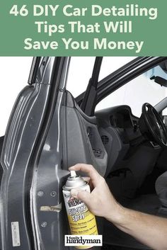 a man is cleaning the inside of a car door with a bottle of cleaner next to it