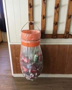 a plastic bag filled with candy sitting on top of a wooden floor next to a wall