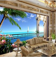 a living room filled with furniture and a large window overlooking the ocean on a sunny day