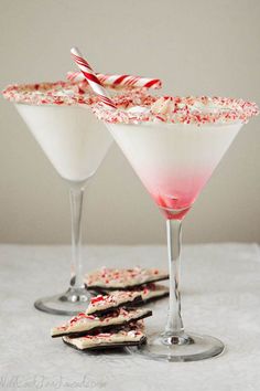 two martini glasses filled with candy canes and sprinkles next to each other