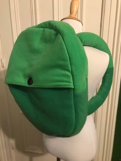 This cosplay backpack inspired by Finn the Human's backpack from Adventure Time. It is crafted out of two different shades of green, just like in the show, and closes with a single button. It is a functional backpack, and is stabilized so it retains the signature comfy, round look of Finn's pack, complete with his funky tube-like backpack straps. The dimensions are a little over 18 inches tall by a little over 13 inches wide. The straps pictured are short to achieve a look as close to the animat Finn The Human Backpack, Finn Cosplay Adventure Time, Finn The Human Cosplay, Finn Backpack, Finn Cosplay, Adventure Time Backpack, Cosplay Backpack, Adventure Time Cosplay, Family Guy Funny