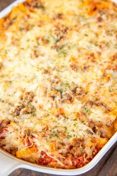 a casserole dish with meat and cheese in it on a wooden table top