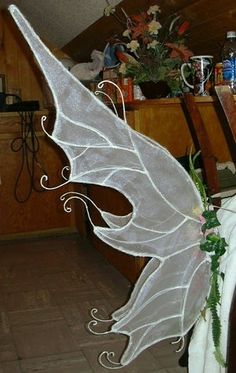 a white fairy wings decoration sitting on top of a table