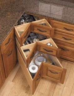 an open drawer in the middle of a kitchen