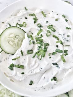 a cucumber and sour cream dip in a white bowl