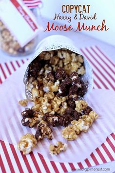 chocolate covered popcorn in a paper bag on top of a red and white table cloth