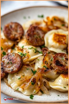 a white plate topped with pasta and sausage