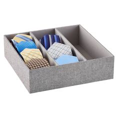 an open drawer with ties in it on a white background