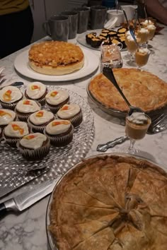 many pies and cupcakes are on the table