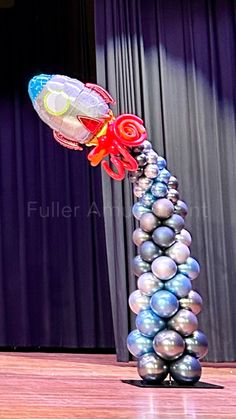 an inflatable balloon is being blown by the wind on top of some balls