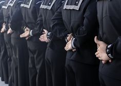 a row of navy officers giving thumbs up