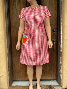 This is SO cute! One of my favorite dresses! This is a lovely red gingham dress with an apple appliqué pocket. Minor wear to the one appliqué. Inside of hem is hand stitched. This zips in the front and comes with a matching strap. Tag has been removed.  Model is a size 6 jeans and approximately 130lbs.  Measurements:  Bust - 38-40 inches Waist - 36 inches Hip - 42 inches Length - 40  inches All sales final! For additional questions, images or issues with your order please contact me!  Vintage pr Preppy Red Cotton Dress, Red Preppy Cotton Dress, Red Cotton Plaid Dress For Picnic, Cute Short Sleeve Plaid Dress For Picnic, Cute Plaid Short Sleeve Dress For Picnic, Retro Short Sleeve Plaid Gingham Dress, Red Short Sleeve School Dress, Preppy Short Sleeve Dress For Picnic, Cute Short Sleeve Plaid Cotton Dress