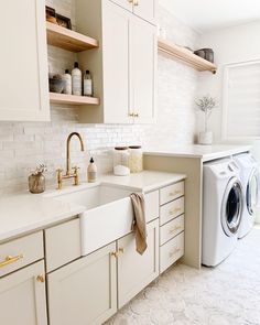 Laundry Room Finishes, Modern Coastal Laundry Room Ideas, Laundry Room Floating Shelves Over Sink, Laundry Room Beige Cabinets, Transitional Laundry Room Design, Mediterranean Laundry Room Design, Cream Cabinets Laundry Room, Spa Laundry Room, Laundry Room Neutral