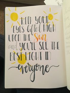 an open notebook with writing on it and a handwritten quote in the middle that says, keep your eyes closed high upon the sun and you'll