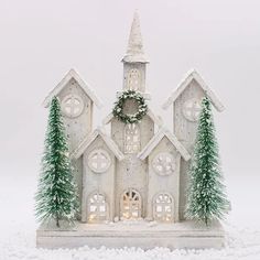 a small white church with christmas decorations on it