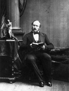 an old black and white photo of a man reading