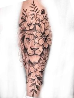 a lion with flowers on it's head is shown in this tattoo art piece