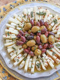 a white plate topped with olives and cheese