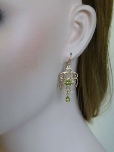 Capture the spirit of vintage appeal & a touch of glamour with these gorgeous Victorian chandelier drop earrings! These superbly crafted earrings have been handmade in 9ct Solid Yellow Gold with reference to a vintage design. A luxurious bezel set oval cut NATURAL Peridot sits in the centre and is surrounded by filigree patterns while a pear shaped bezel set NATURAL Peridot dangles from the chandelier capturing the attention of onlookers. French hook wires attach to these earrings which will Nickel-free Peridot Elegant Jewelry, Elegant Peridot Nickel-free Jewelry, Elegant Nickel-free Peridot Jewelry, Classic Gold Peridot Jewelry, Elegant Pierced Peridot Jewelry, Classic Gold Jewelry With Peridot, Elegant Oval Peridot Earrings, Elegant Peridot Earrings For Anniversary, Elegant Peridot Earrings For May Birthstone