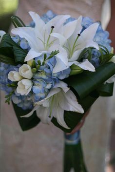 a bridal bouquet with blue and white flowers