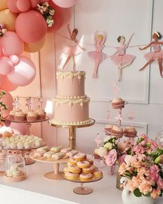 a table topped with lots of desserts and balloons