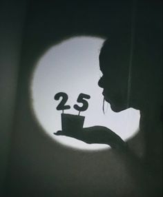 a woman holding a cup with the number twenty five on it