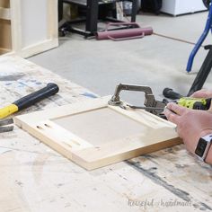 a person working with wood and tools on a table