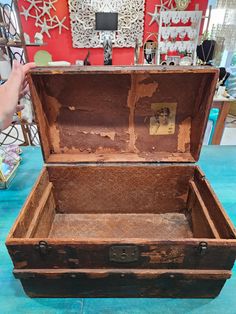 an old trunk sitting on top of a blue floor