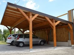 a car is parked under a wooden structure