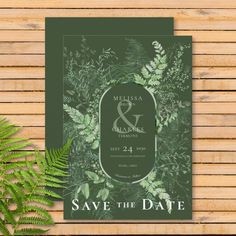 save the date card with fern leaves and greenery in green, on wooden background