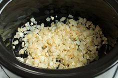 onions are being cooked in the slow cooker