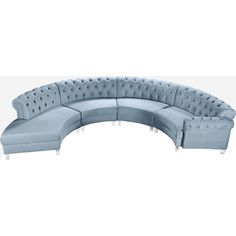 a blue sectional couch sitting on top of a white floor