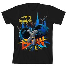 a black batman t - shirt with the words, batman and cityscape in the background