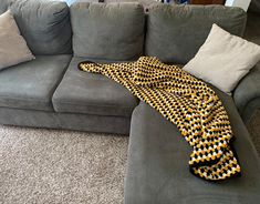 a couch that has a blanket on top of it