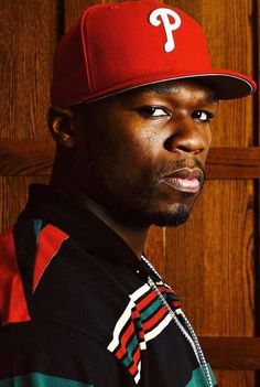 a man wearing a red baseball cap with the philadelphia phillies on it