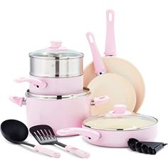 a pink cookware set with utensils and cooking implements in it, including pots and pans