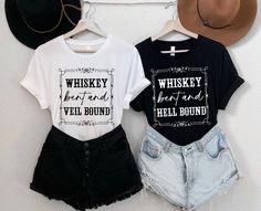 two t - shirts and shorts hanging on a wall next to each other with cowboy hats