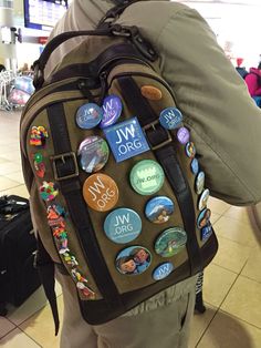 a person with a backpack that has many different buttons on it