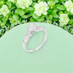 a diamond ring sitting on top of a green table