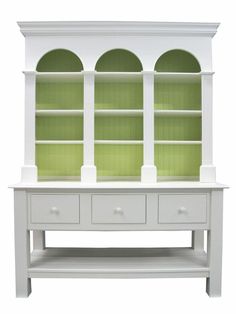 a white bookcase with green glass doors and drawers on the bottom shelf, against a white background