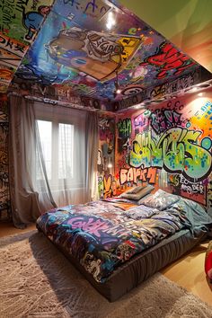 a bed with lots of graffiti on the walls in a room filled with carpeted flooring