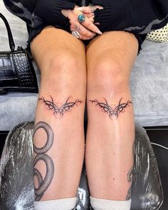 the legs of a woman with tattoos on them