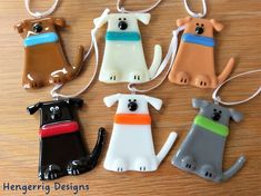 four ceramic dog ornament hanging on a wooden table